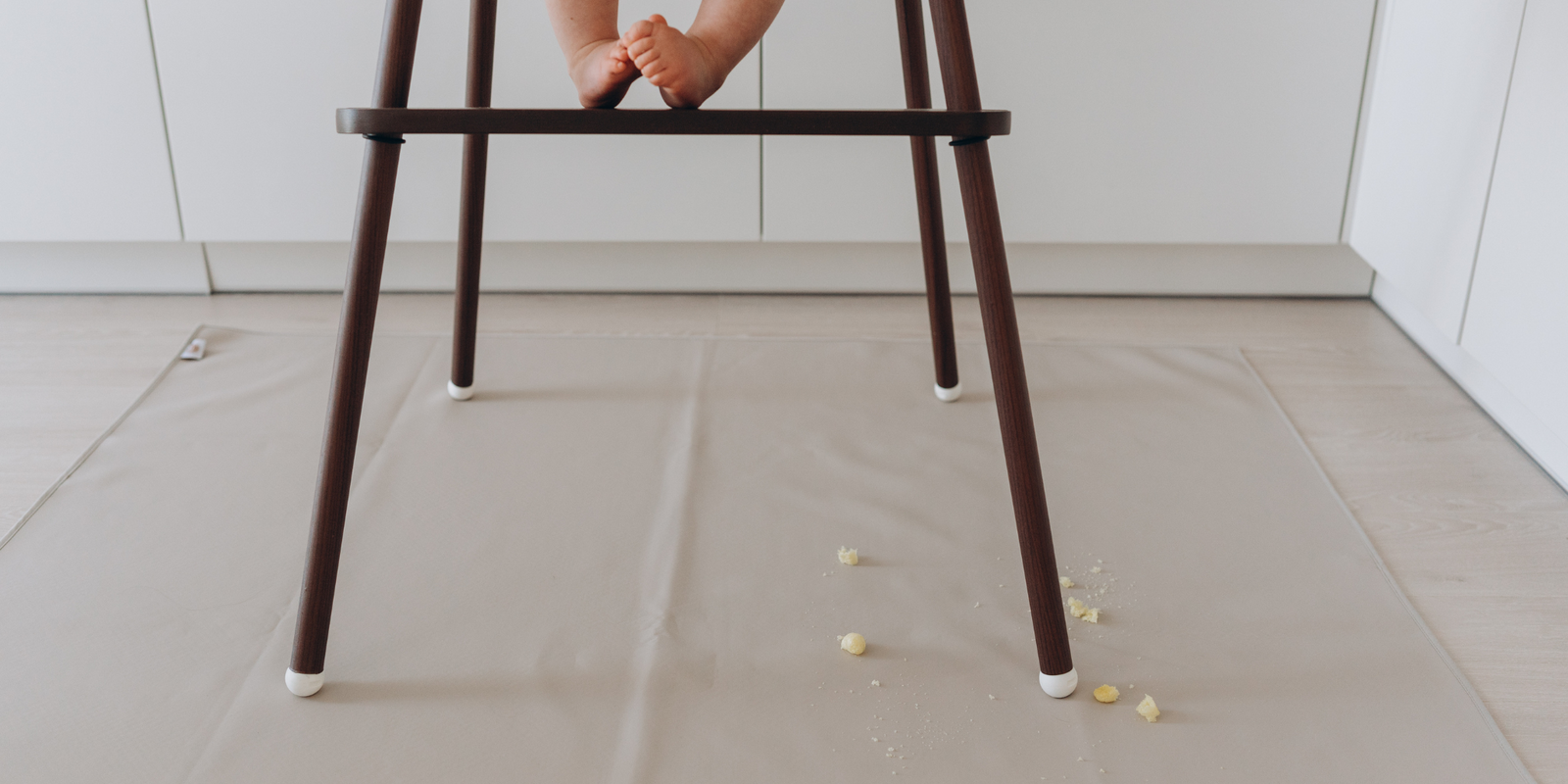 baby resting feet on IKEA Antilop highchairs with footrest and leg wraps by AZEbabydream