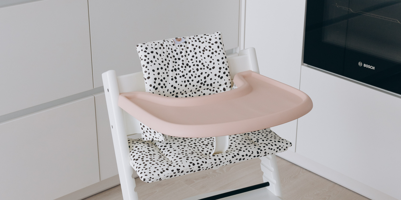 Stokke Tripp Trapp highchairs with wipe-clean cushion in dots on white print and silicone placemat in peach by AZEbabydream