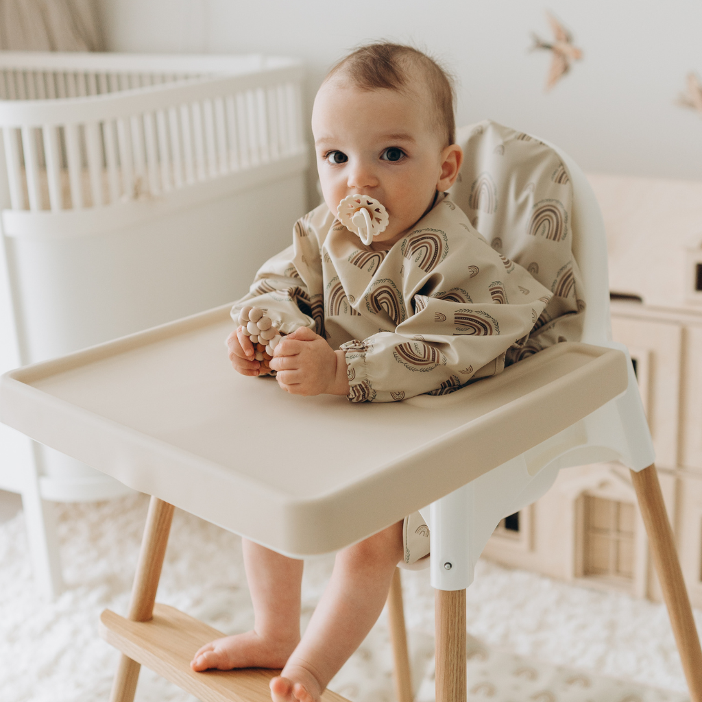  Baby sitting on stokke high chair