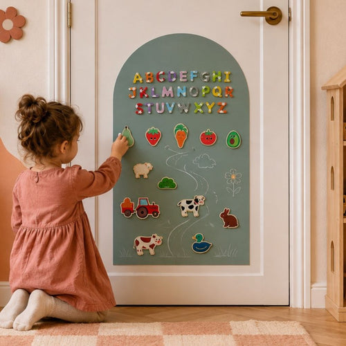 Girl playing with an AZEbabydream magnetic chalkboard wall sticker using magnetic tiles and drawing accessories