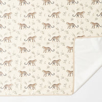 Leopards Parade messy mat under high chair with baby eating