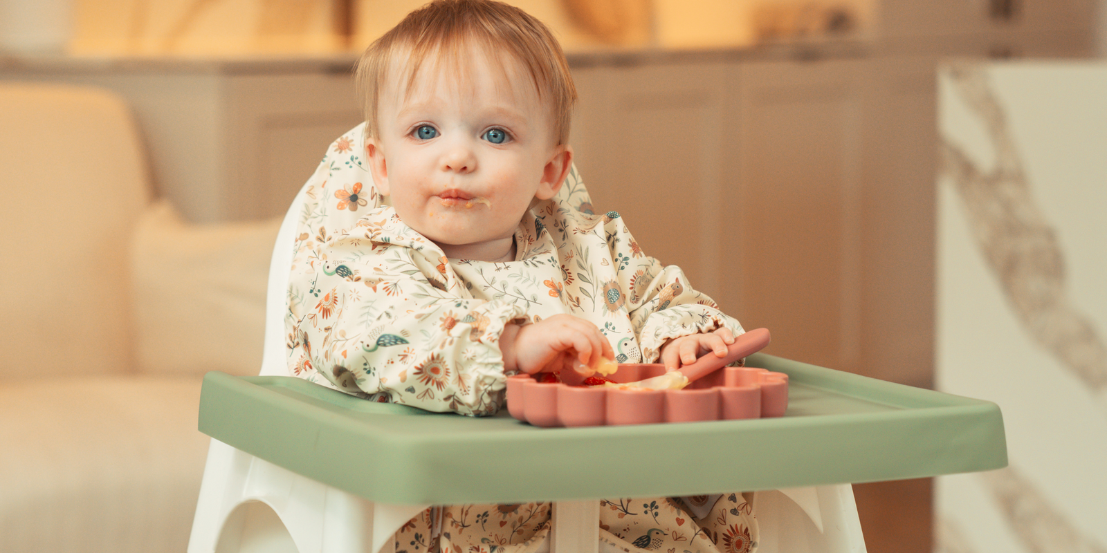 Baby seated in ikea highchairs and eating in wipe clean long sleeve weaning bib by azebABYDREAm