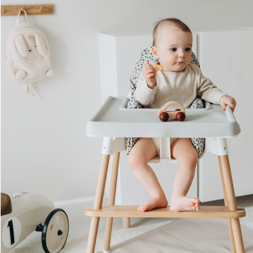 A boy on Ikea footrest highchair 