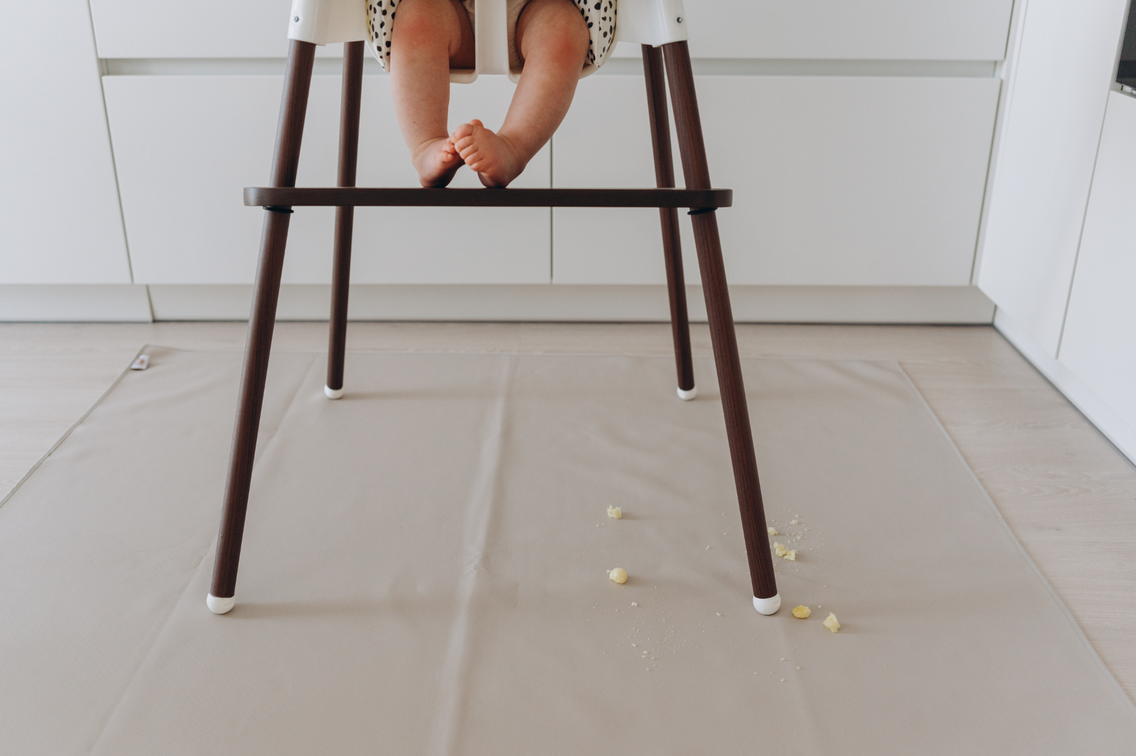 Baby seated in ikea highchairs and resting feet on wooden footrest by azebABYDREAm