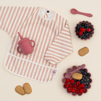 Baby using Rose 4 piece weaning set at high chair