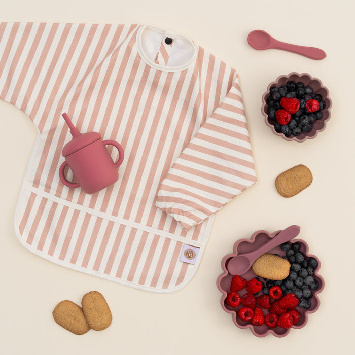 Baby using Rose 4 piece weaning set at high chair