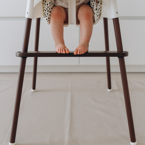 Baby seated in ikea highchairs and resting feet on wooden footrest by azebABYDREAm