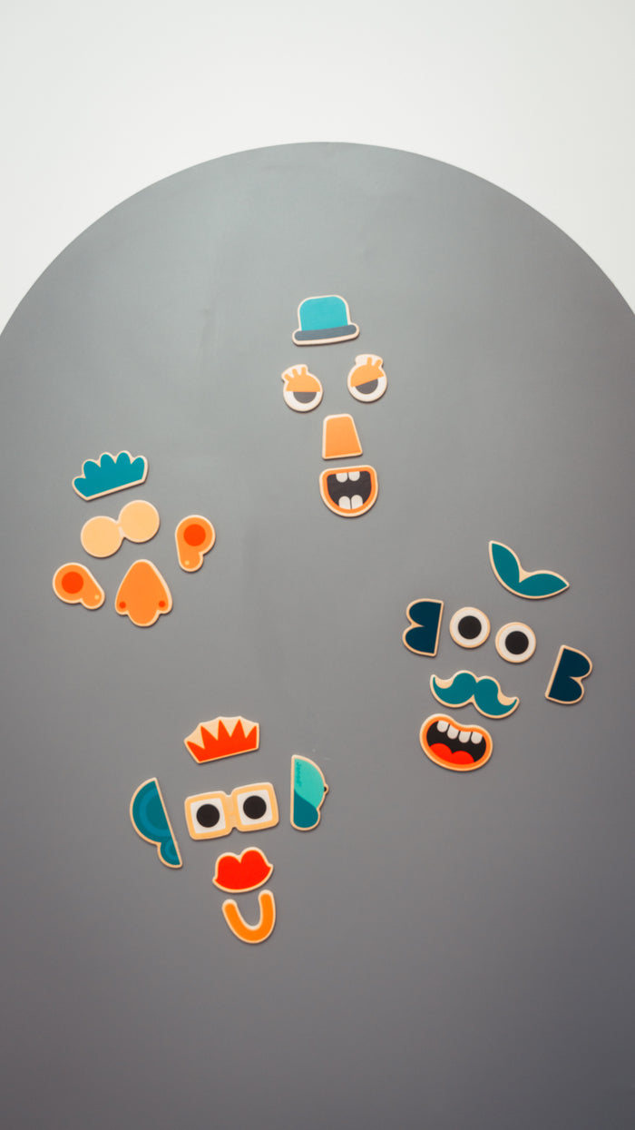 Child playing with magnets on Grey Dawn chalk magnet wall sticker